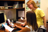 Library Catalogers confer regarding KentLINK�s records for a new DVD.