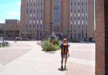 Student venturing towards the Main Library from the Kiva