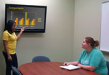 Students prepare for a class presentation in the Presentation Practice Room on the second floor of the Main Library.