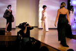 A Teleproductions staff member on remote location capturing the senior fashion design show.