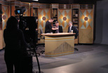 A student employee helps mic the talent for PBS 45 & 49's NewsNight Akron in Teleproductions' Studio A.