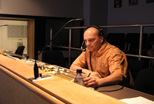 A staff member in the Teleproductions control room prepares to direct an in-studio production.