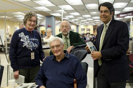 Library staff and Community member smiling